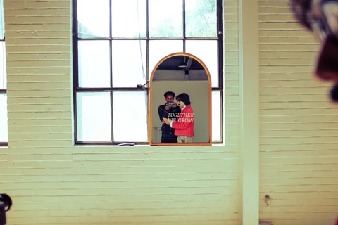 Behind the photograph: a camera and the artist reflected in the studio mirror